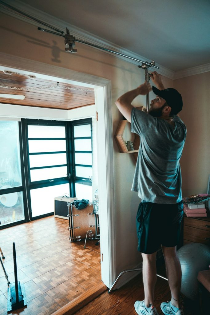 man-fixing-cables-beside-door-tbax8vev4hy